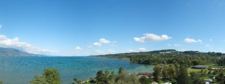 Neuenburgersee von Yverdon aus gesehen. Einige flache Quellwolken am Himmel.
